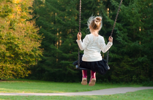 little girl on swing